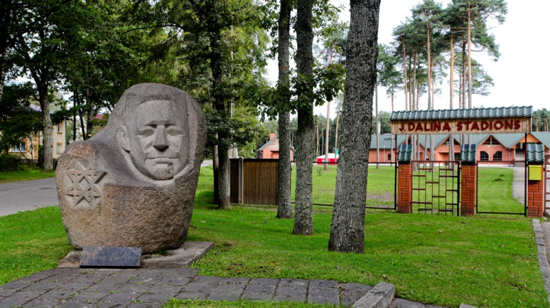 Akmens piemineklis Jānim Daliņam pie stadiona ieejas